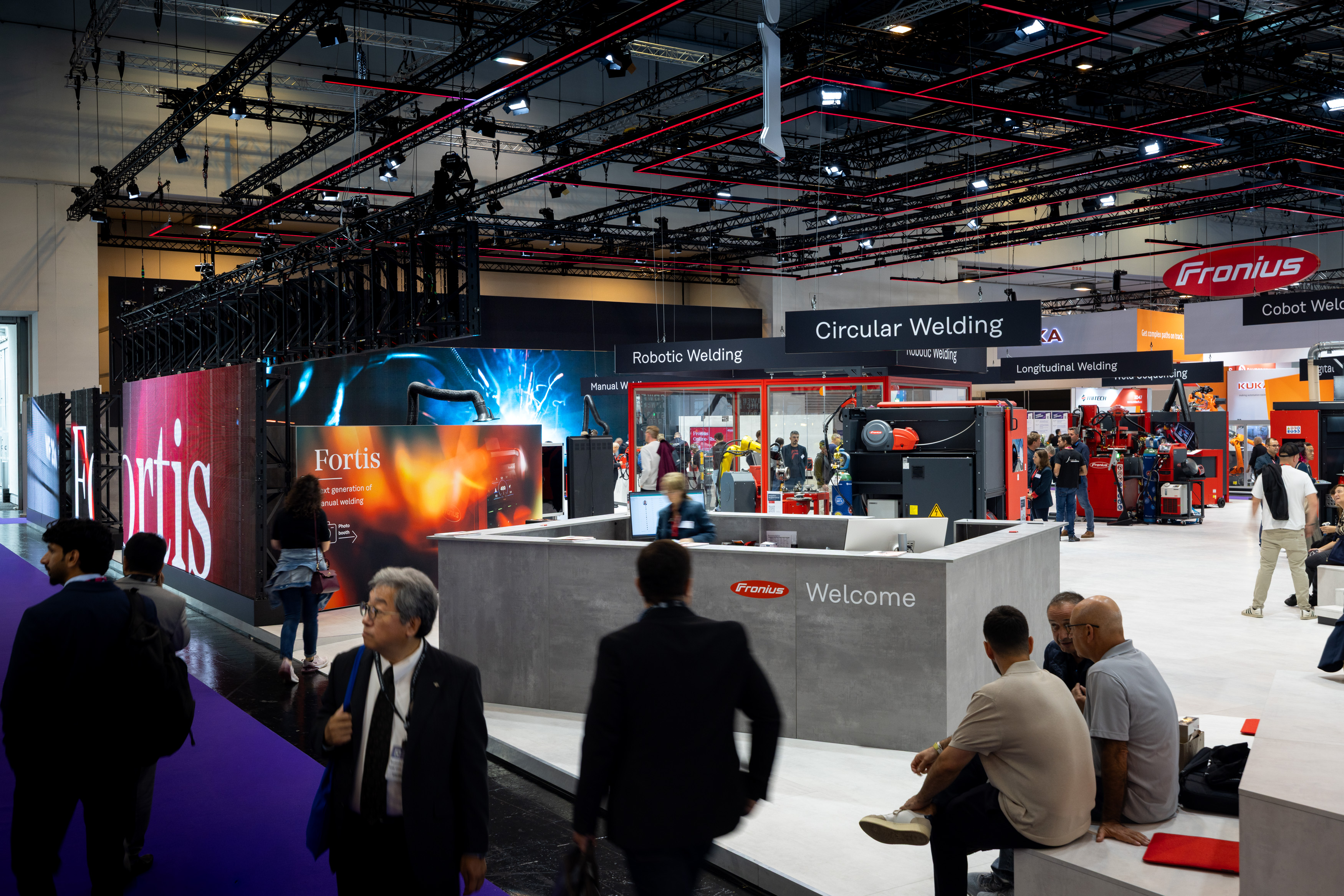 Fronius International's trade show booth, designed by Holtmann+, in an exhibition hall in Essen in 2025 at the Welding and Cutting trade show.